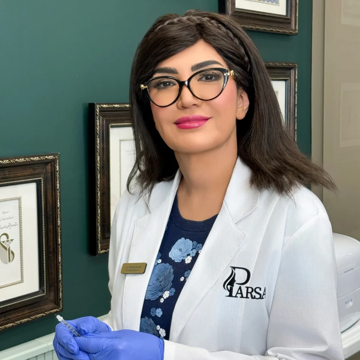 Clinician in blue gloves preparing an injectable treatment for a reclining patient